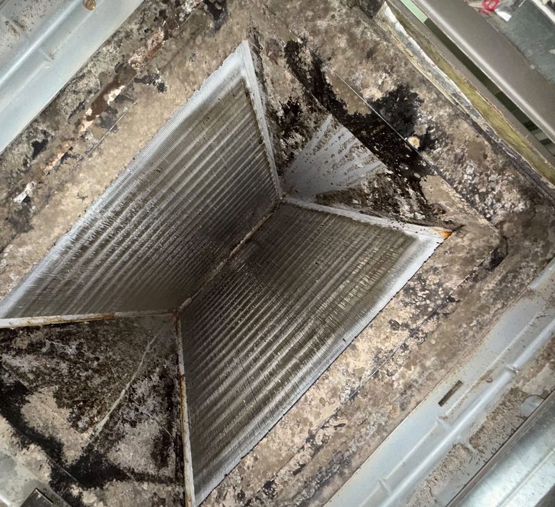 Supply register grille heavily loaded with dust and debris before cleaning